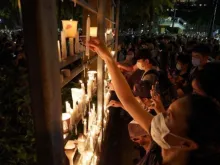 People light candles at a Tiananmen vigil at Victoria Park in Hong Kong, June 4, 2020.